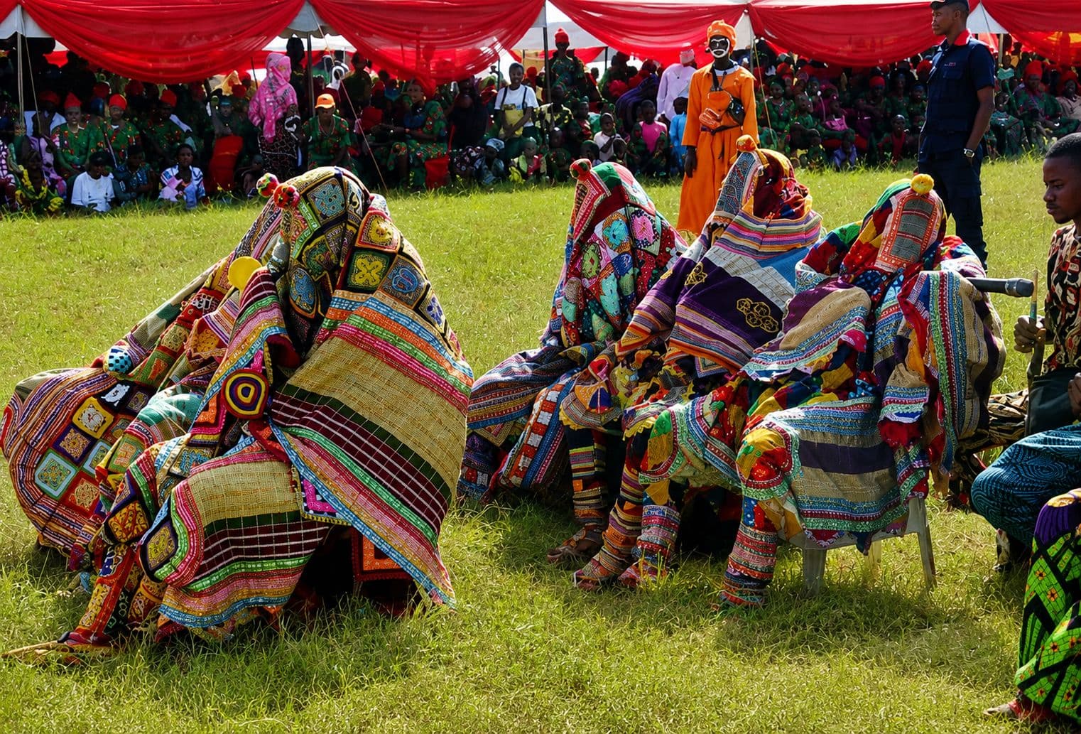 Egungun masquerades in traditional patchwork costumes at a cultural festival